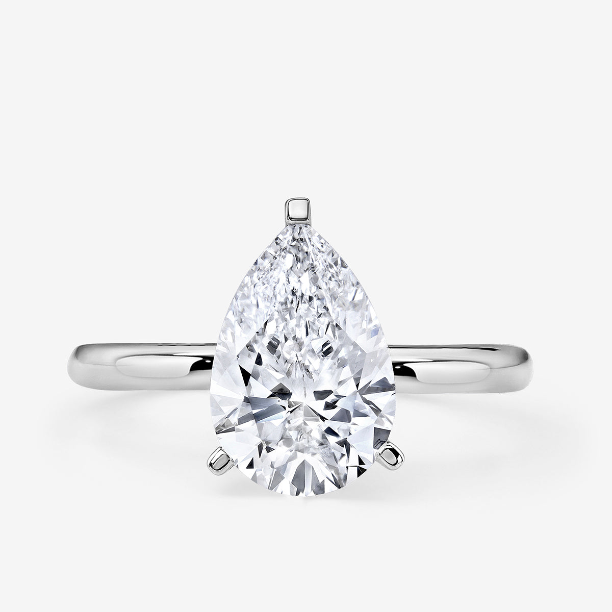 The Keemti Jewels EVERDEW Pear Solitaire Ring features a large pear-cut diamond on a simple silver band.