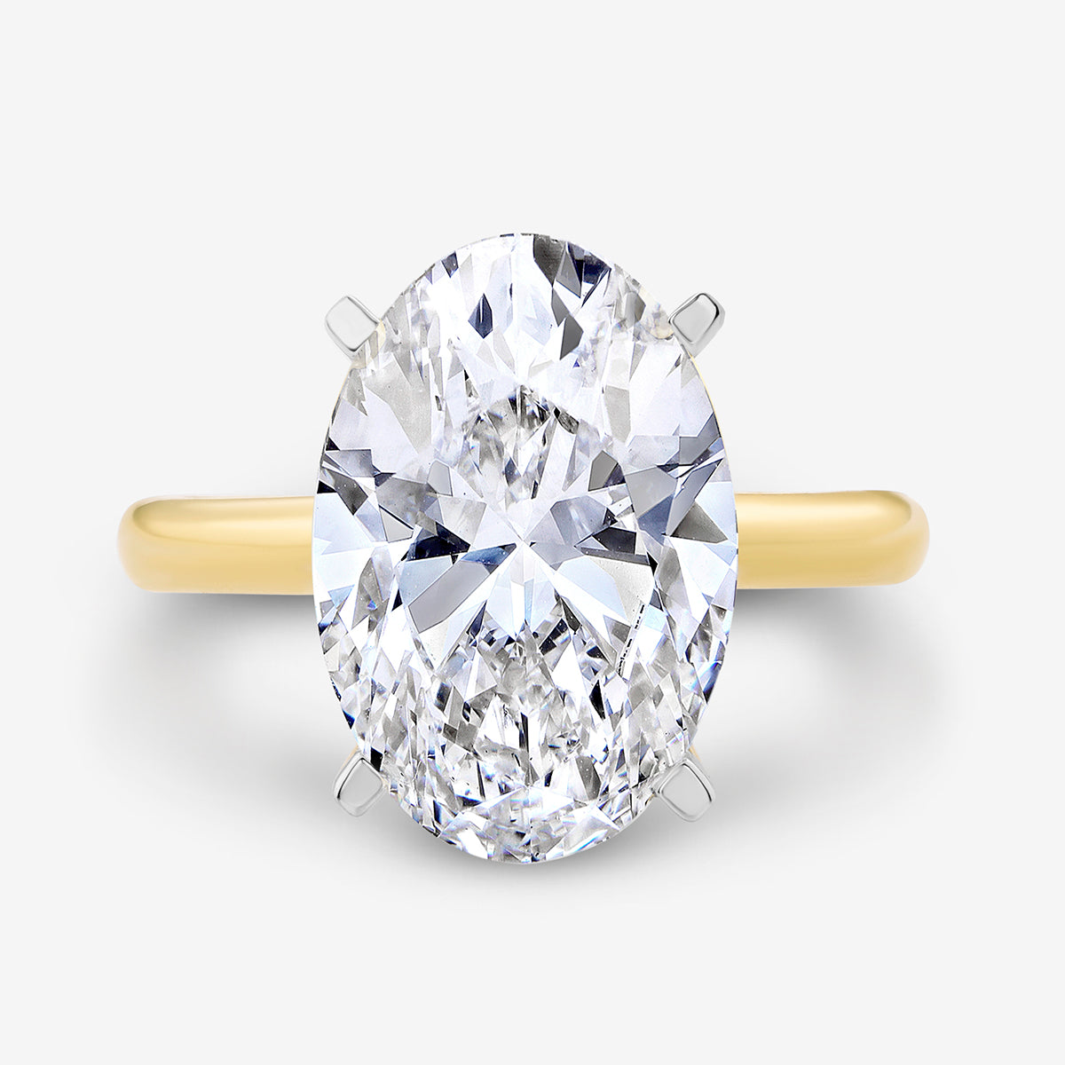 The MINIMAL Oval Solitaire RING by Keemti Jewels features a luminous gold band with a classic oval centerpiece.