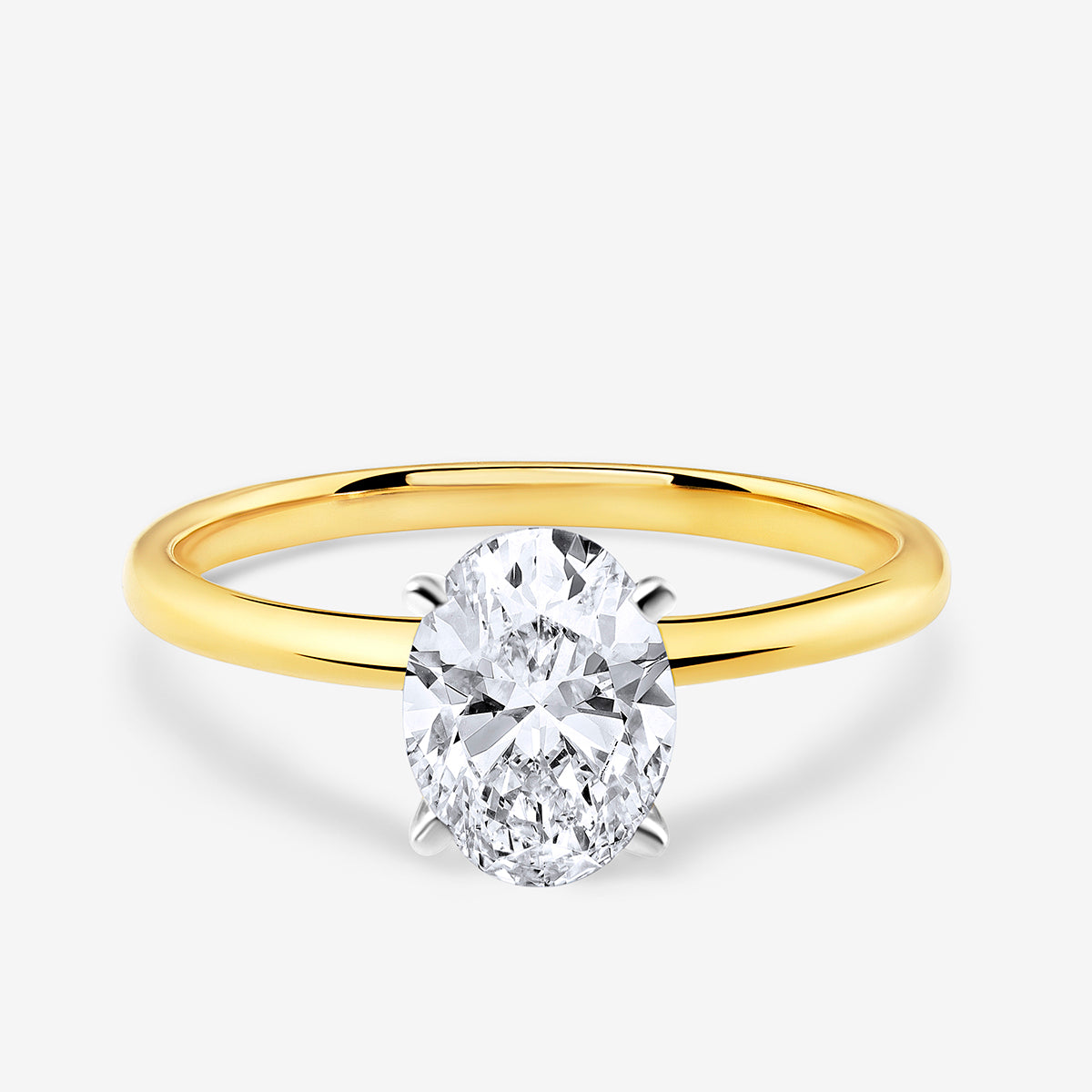 The MINIMAL Oval Solitaire RING by Keemti Jewels features a gold band and an oval diamond in a four-prong setting.
