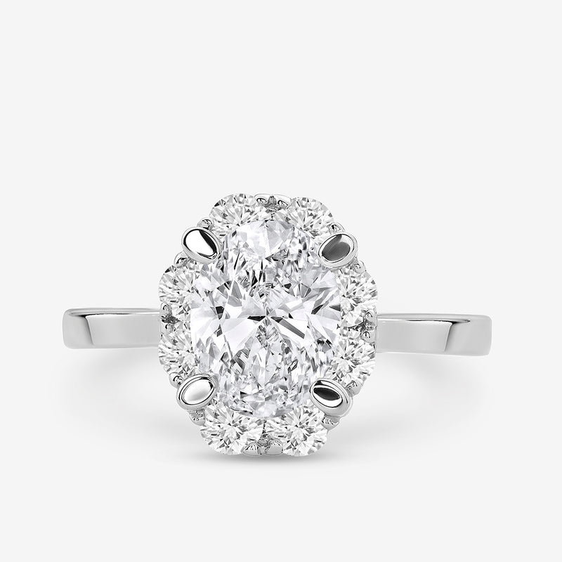 The CLASSIC Oval Mount Halo RING by Keemti Jewels features a prong-set oval and diamond halo on a white gold band.