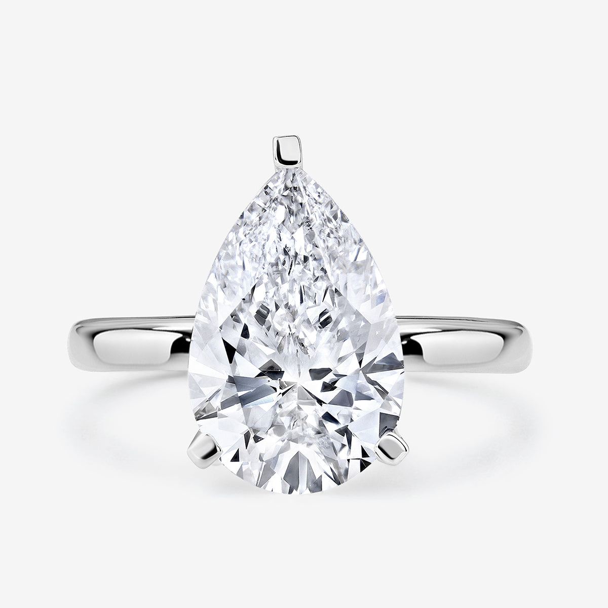 The TIMELESS Pear Solitaire RING by Keemti Jewels features a large pear-cut diamond in a classic silver setting.