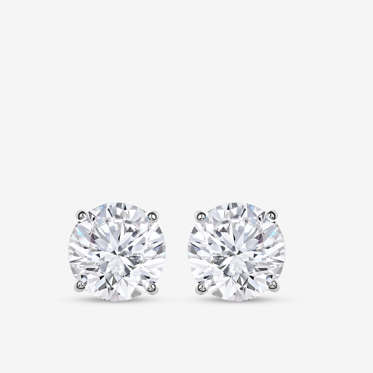 Keemti Jewels TIMELESS Solitaire Stud Earrings feature sparkling stones in four-prong settings on a white background.