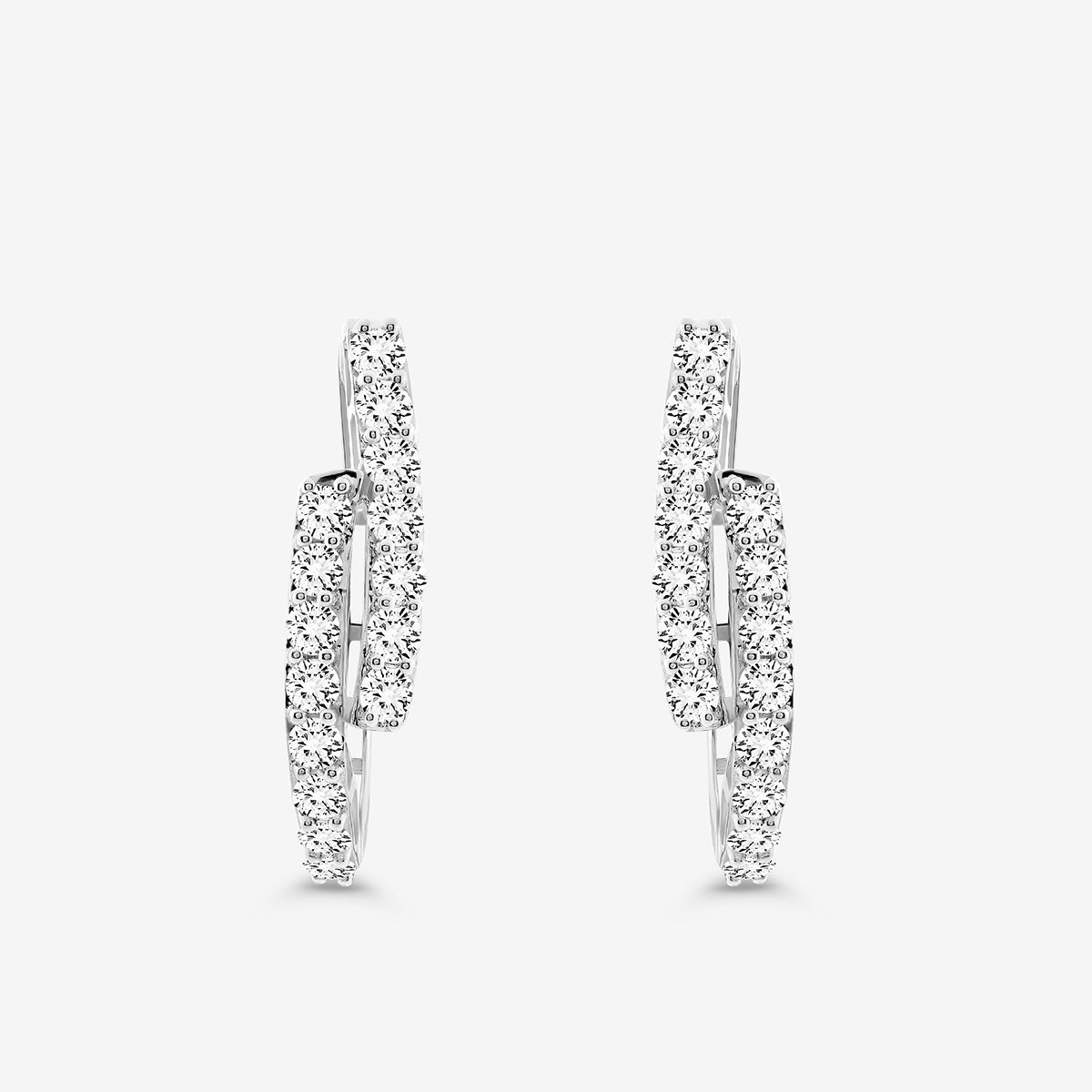 The SOLACE Arc Huggie Earrings by Keemti Jewels are silver hoops with two overlapping rows of sparkling white stones—an essential everyday jewelry piece, shown against a plain white background.