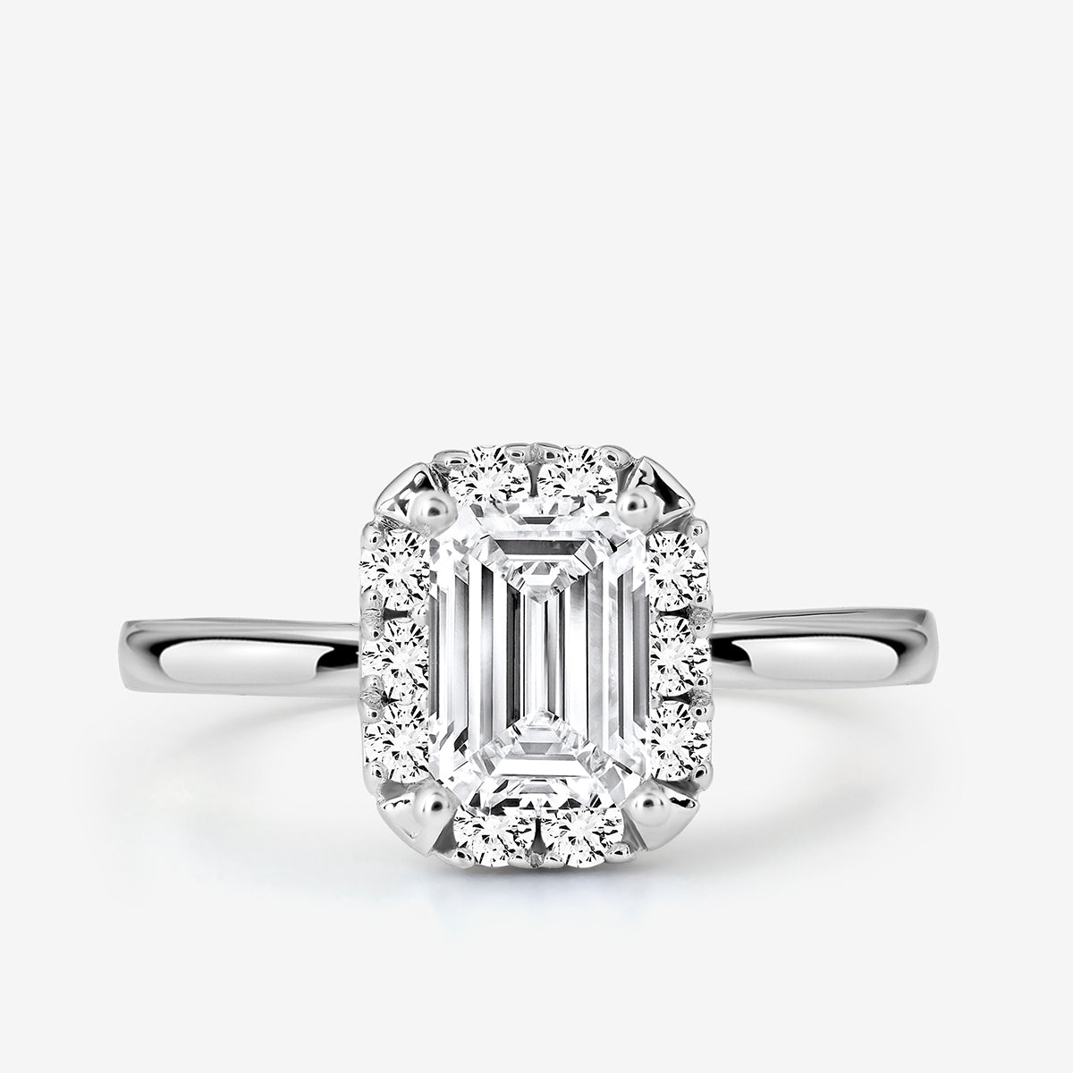The EMERA Halo Solitaire Ring by Keemti Jewels features an emerald-cut in white gold with pavé and halo diamonds.