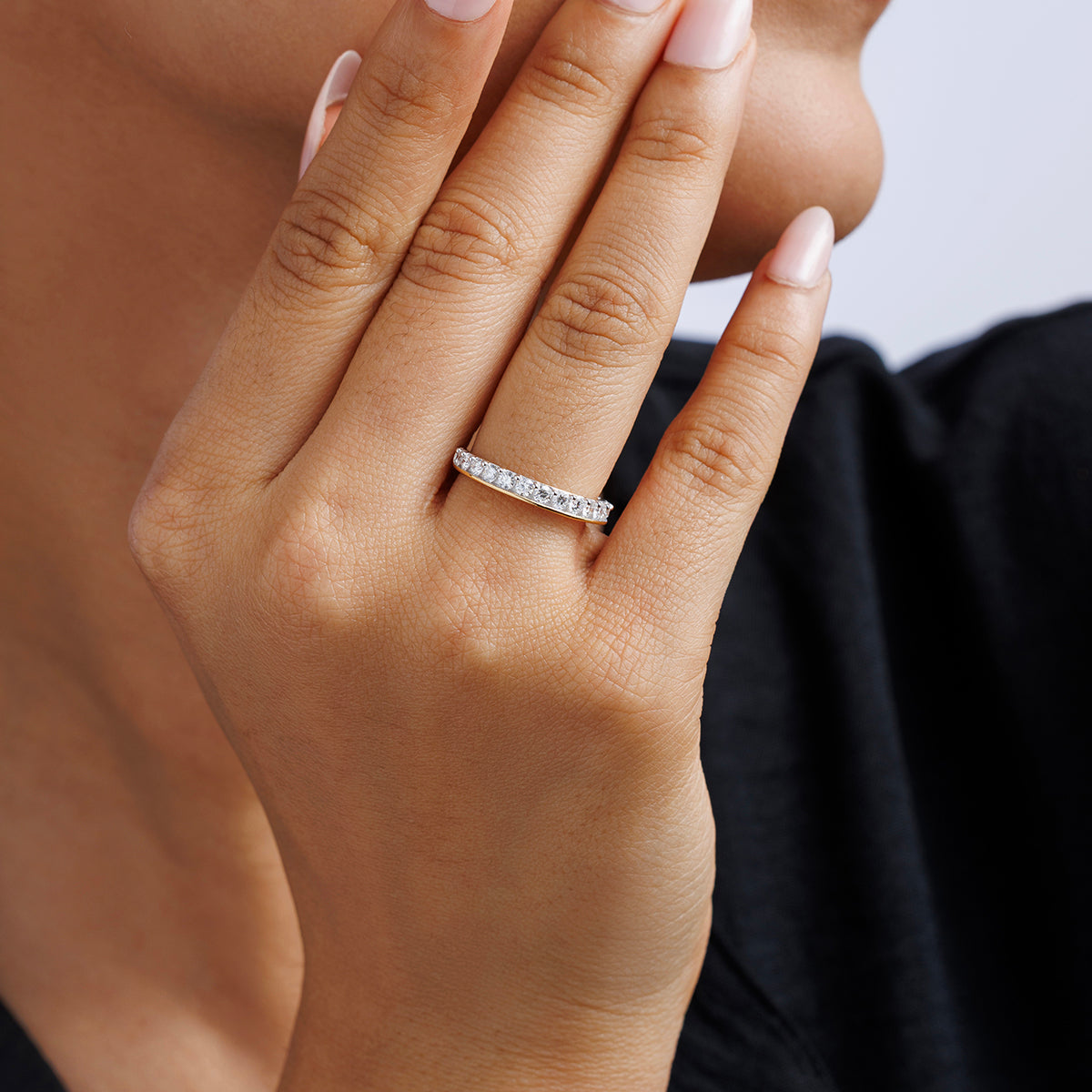 Half Eternity ring on finger, white round pavé stones on slim silver vermeil band
