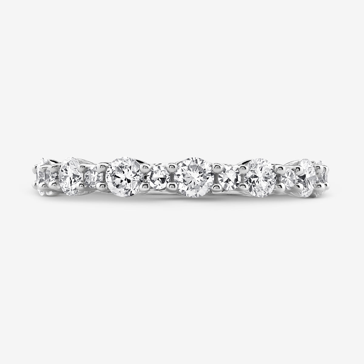 The GEOMETRIC Eternity RING by Keemti Jewels is a white gold band with round diamonds in shared prong settings.