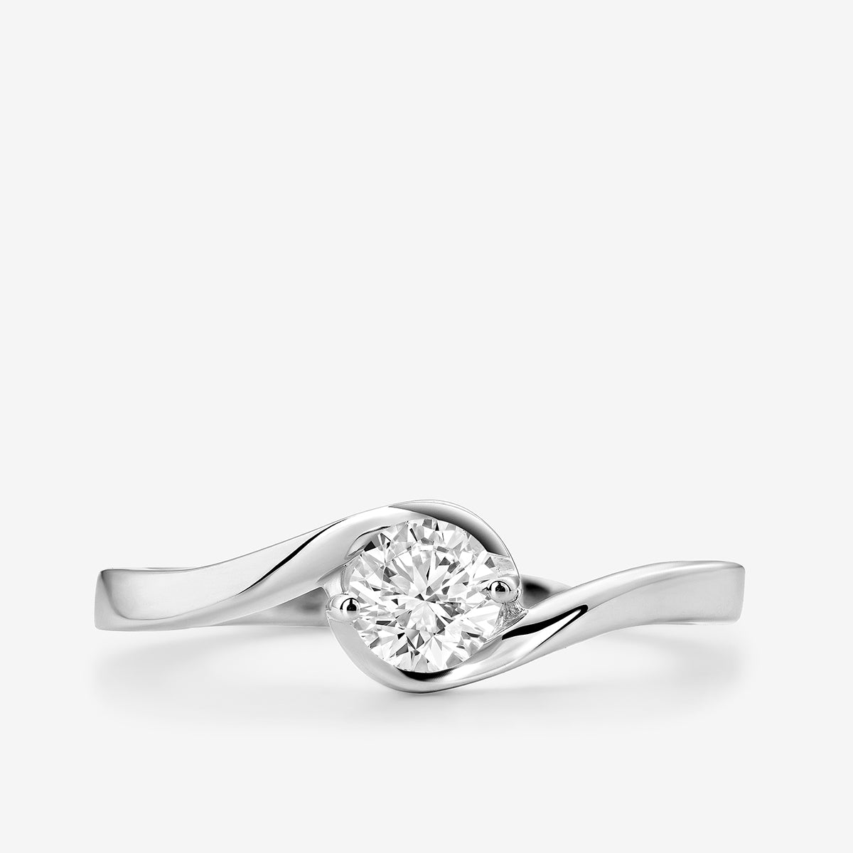 The RADIANT Swirl RING by Keemti Jewels features a round diamond on white gold with a modern, delicate design.