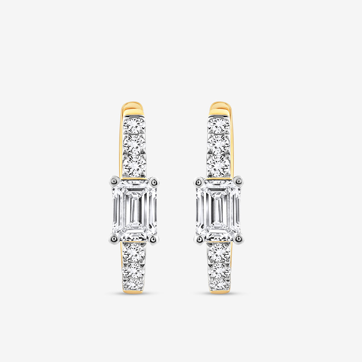 AERIS Emerald Huggie Earrings by Keemti Jewels feature baguette-cut centers and round diamonds on a white backdrop.