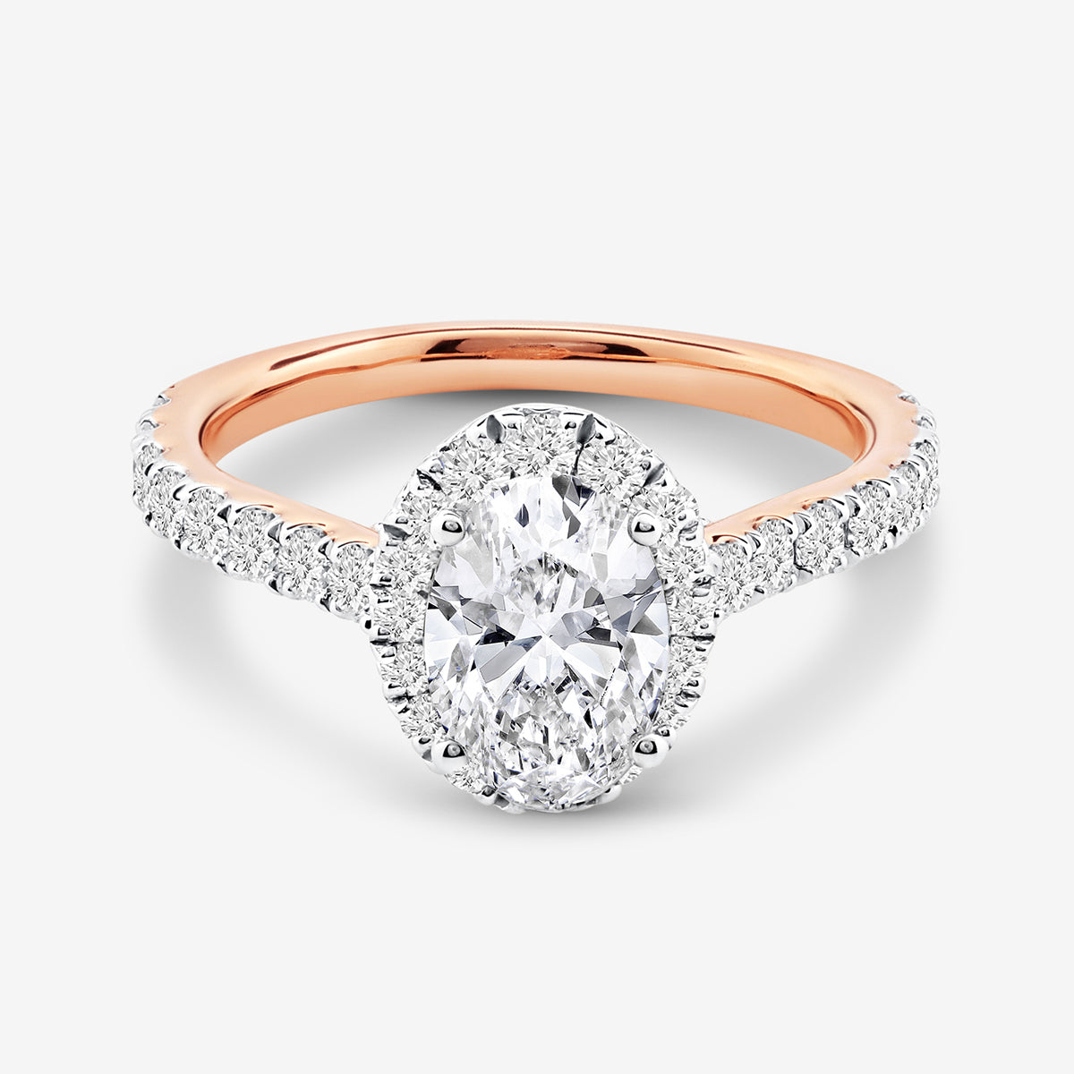 The CLASSIC Oval Mount Solitaire RING by Keemti Jewels features a rose gold band and pavé diamonds, shown on white.