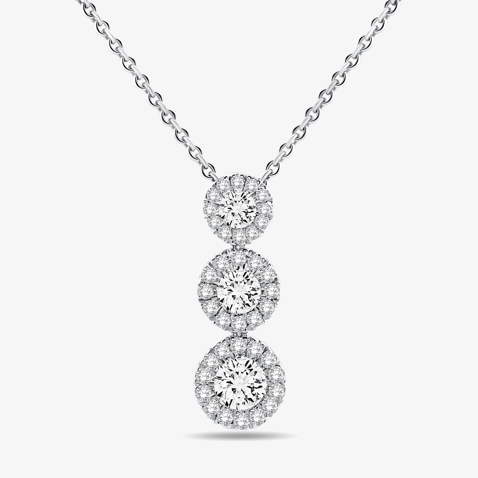 Silver three halo circles stacked on a cable chain pendant necklace.