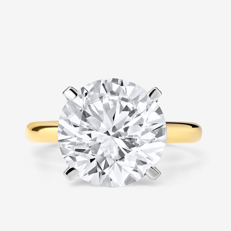 The ELEGANT Round Solitaire RING by Keemti Jewels features a classic four-prong round-cut diamond setting.