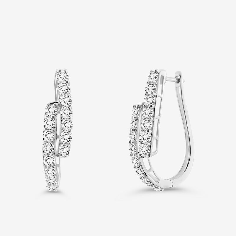 The SOLACE Arc Huggie EARRINGS by Keemti Jewels feature elegant curved hoops with two rows of sparkling white gemstones, displayed on a plain white background—an ideal choice for everyday essential jewelry.