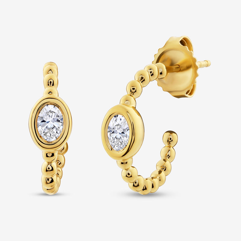 Oval hoop earrings, side view, gold finish with embedded clear crystal and beaded edge