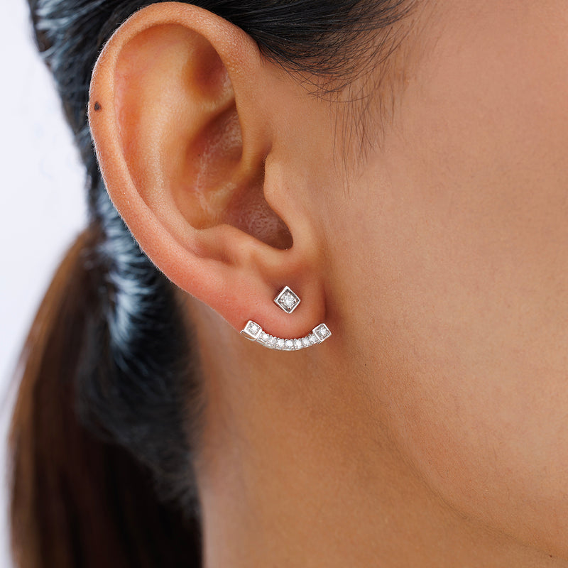 Close-up of an ear wearing Keemti Jewels ELEGANZA Ear JACKETS: a square stud and arc bar with small stones.