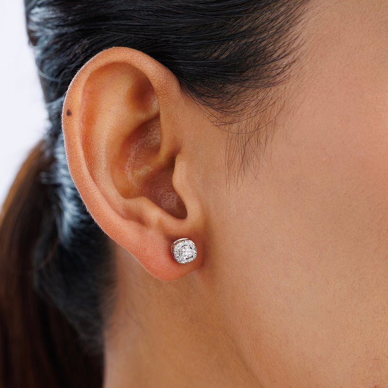 Close-up of a person’s ear wearing Keemti Jewels CHIC Halo Stud EARRINGS, featuring minimal diamonds in silver.