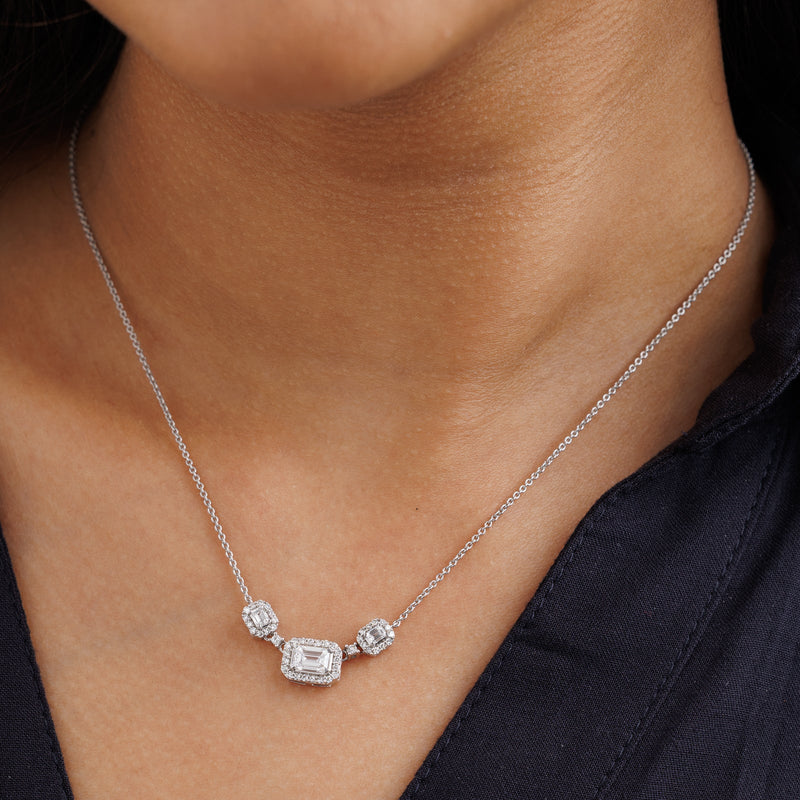 Necklace worn close-up: three emerald-cut square stones on a silver-tone chain