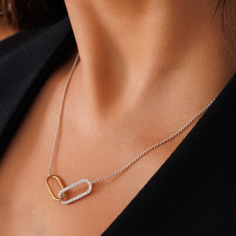 Necklace on collarbone: silver chain with gold-and-silver pavé infinity link