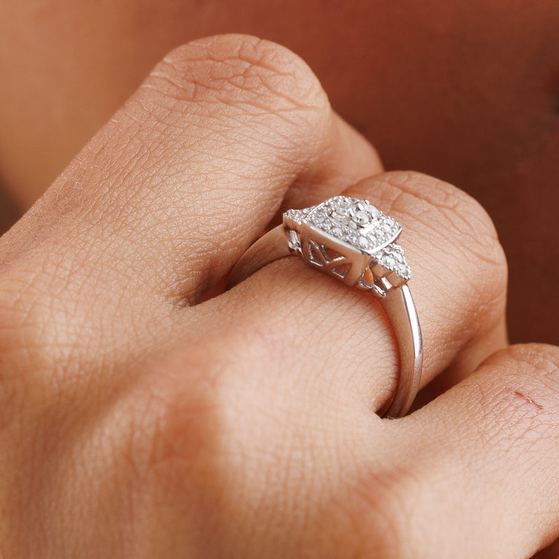 Diamond cluster ring on hand, cushion-shaped halo with split shank details