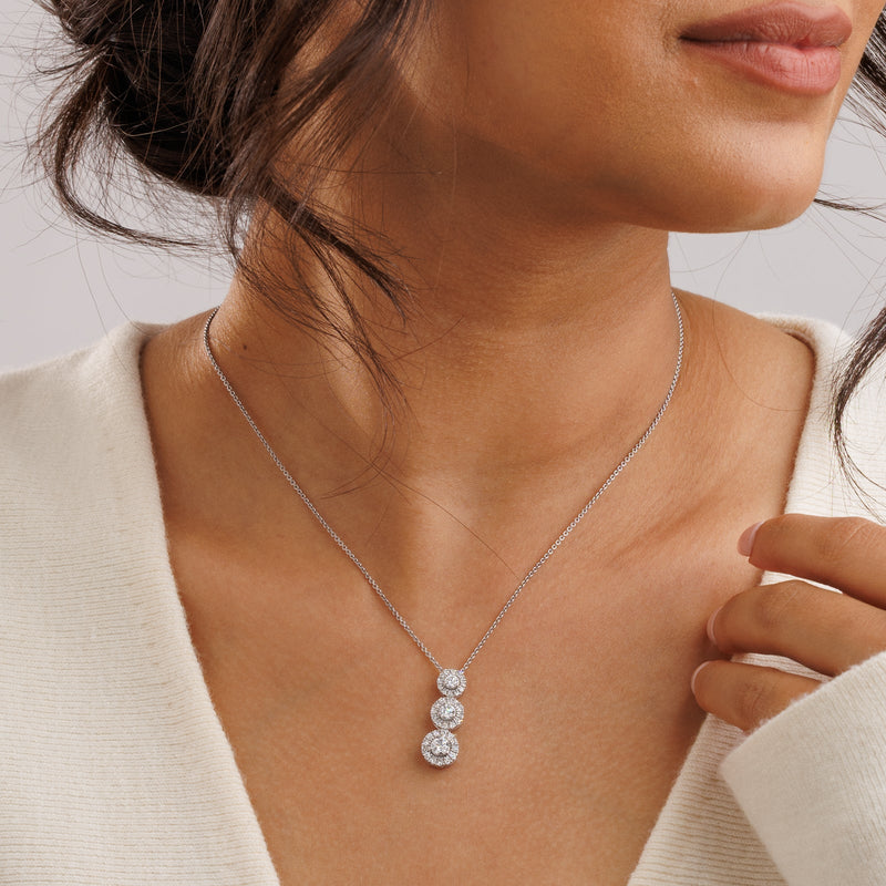 Three halo necklet worn at the collarbone on a fine silver chain.