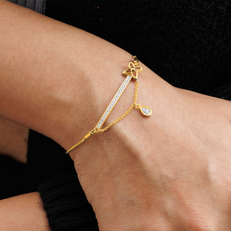 Keemti Jewels' Dangle Bloom Bolo Bracelet: gold chain, dainty motifs, flower charm, and teardrop gem.