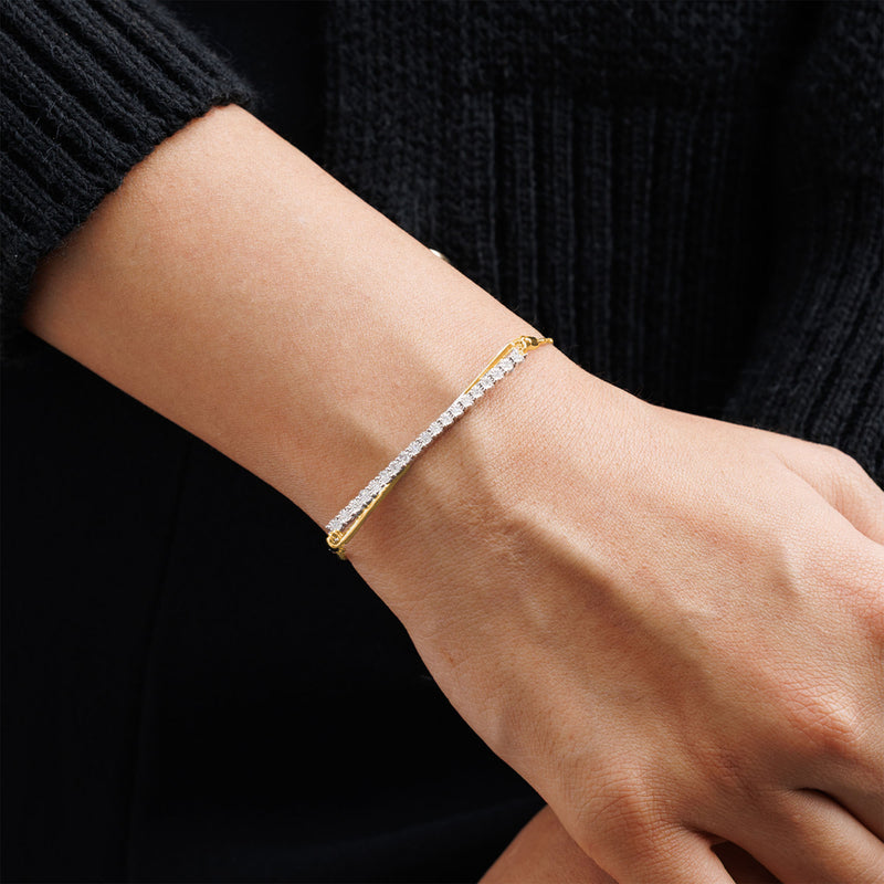 Keemti Jewels' Asymmetric Spark Bolo Bracelet with lab-grown diamonds adds glamour to a classic black sweater look.