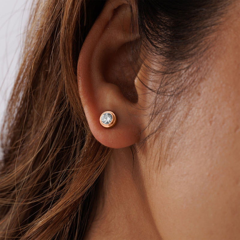 A close-up of an ear wearing Keemti Jewels' Classic Bezel Stud Earrings—ideal for modern, minimalist everyday style.