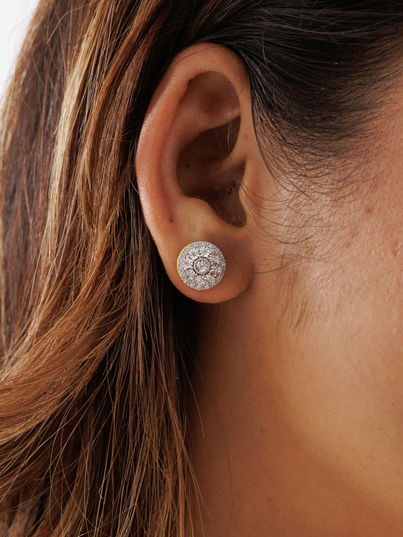 Close-up of a woman’s ear in brown hair wearing Keemti Jewels' Halo Bloom Stud Earrings: radiant silver diamond studs.