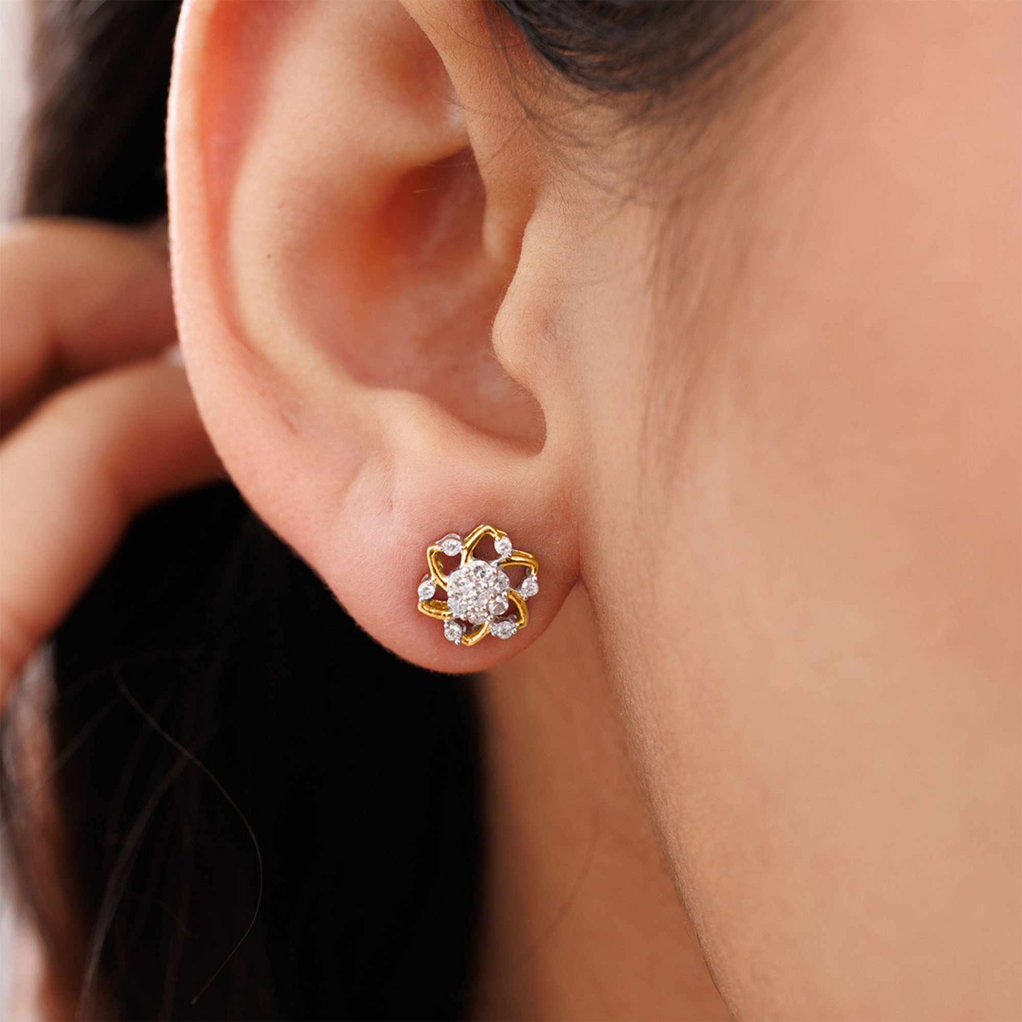 Close-up of an ear with Keemti Jewels' Floral Essence Stud Earrings—gold and diamonds for a feminine touch.