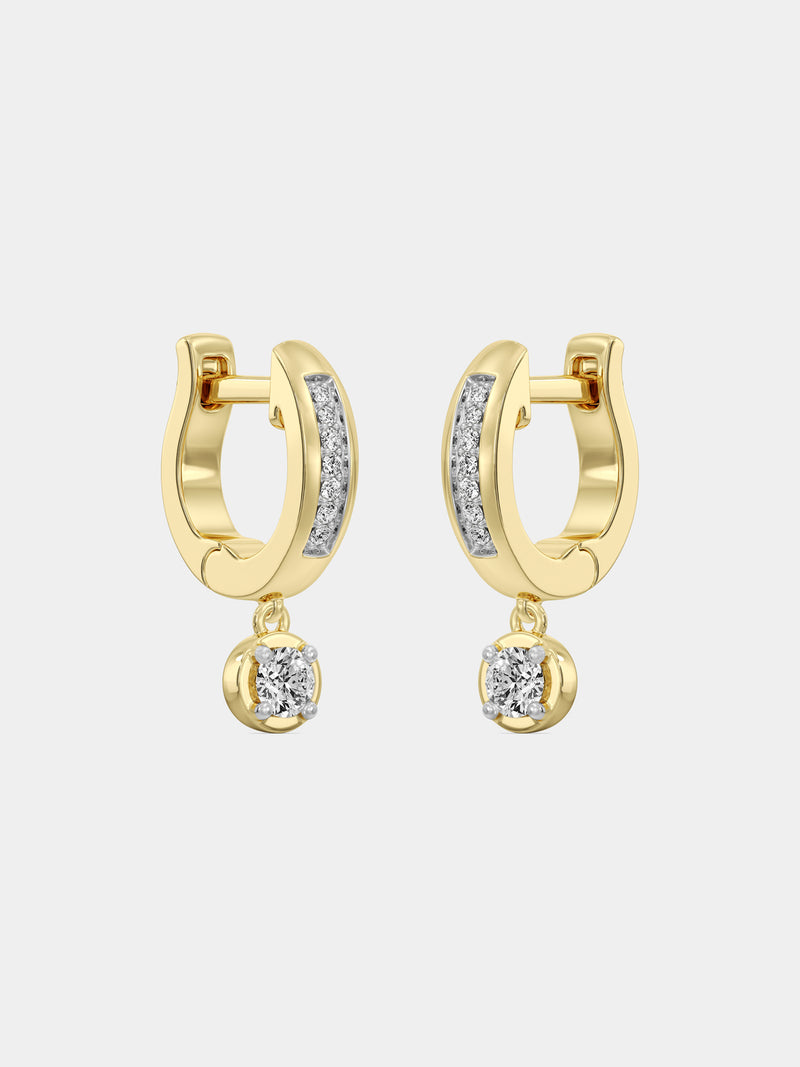Close-up of a woman's ear wearing Keemti Jewels Mini Hoop Drop Earrings with a dangling clear gemstone.