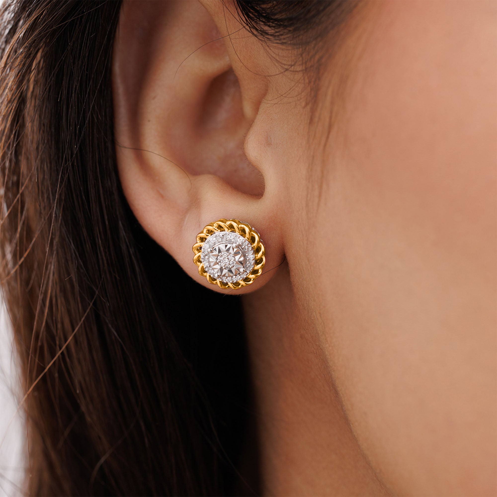 Close-up of an ear wearing Keemti Jewels' Aurora Cluster Stud Earrings with gold, diamonds, and pink-plated accents.
