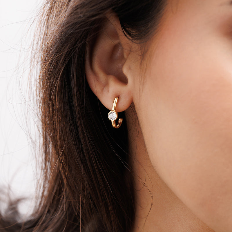 Keemti Jewels Orbit Glow Hoop Earrings: gold half-hoops with bezel-set diamond and starburst, front and side views.