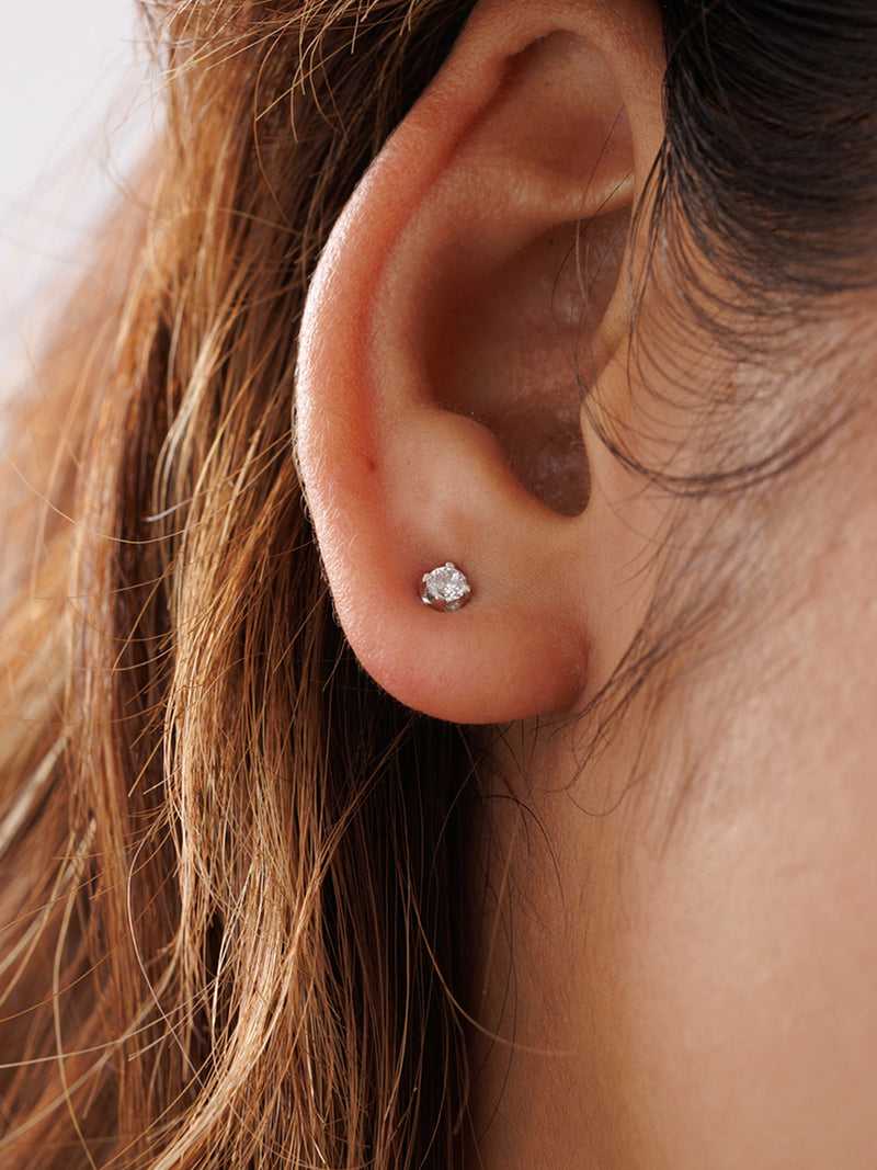 A close-up of a person’s ear wearing Keemti Jewels’ Morning Dew Diamond Stud Earrings in elegant white metal.