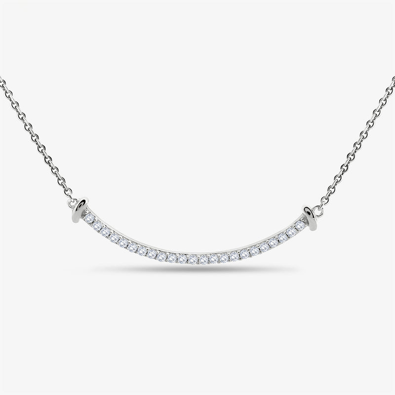 The Aurelia Arc Necklet by Keemti Jewels features a curved silver bar with diamond accents for modern sophistication.