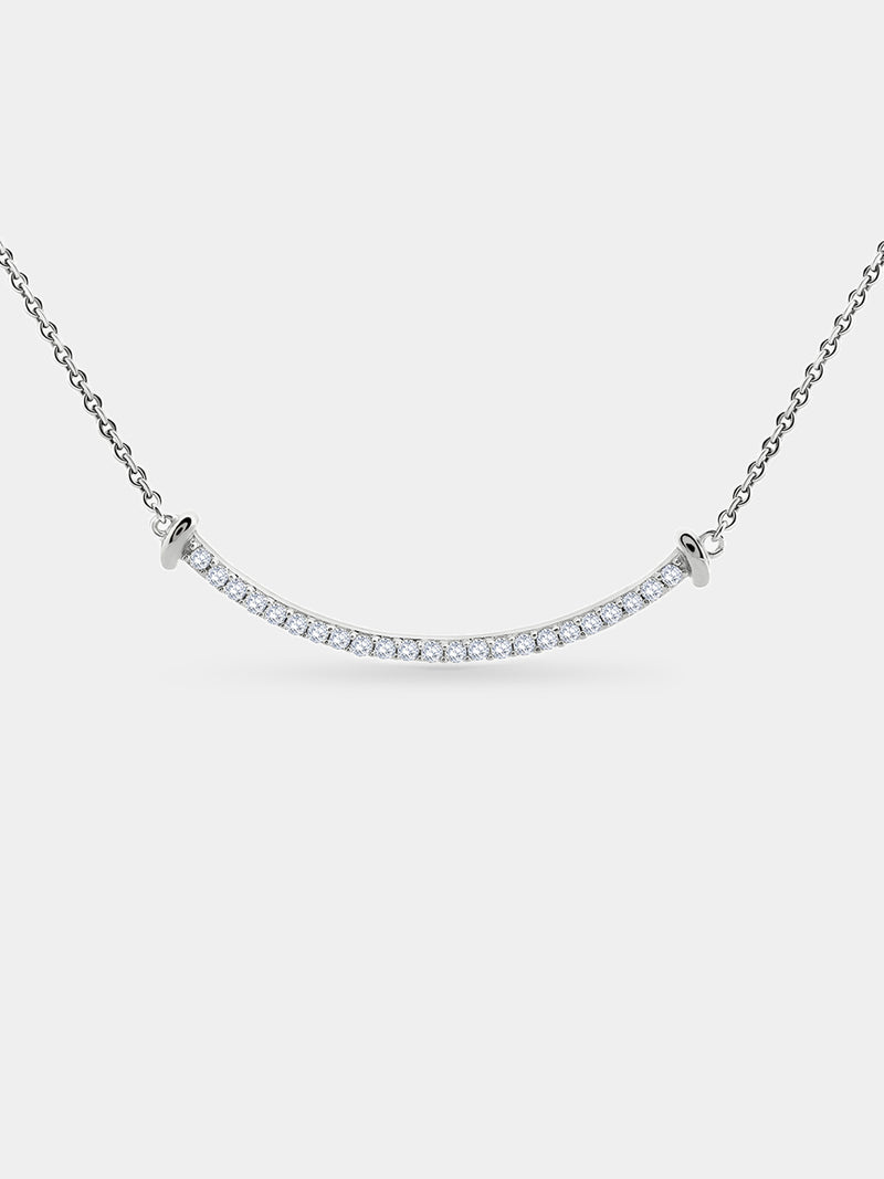 The Aurelia Arc Necklet by Keemti Jewels features a curved silver bar with diamond accents for modern sophistication.