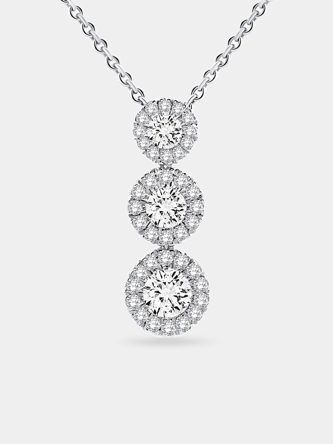 Silver three halo circles stacked on a cable chain pendant necklace.