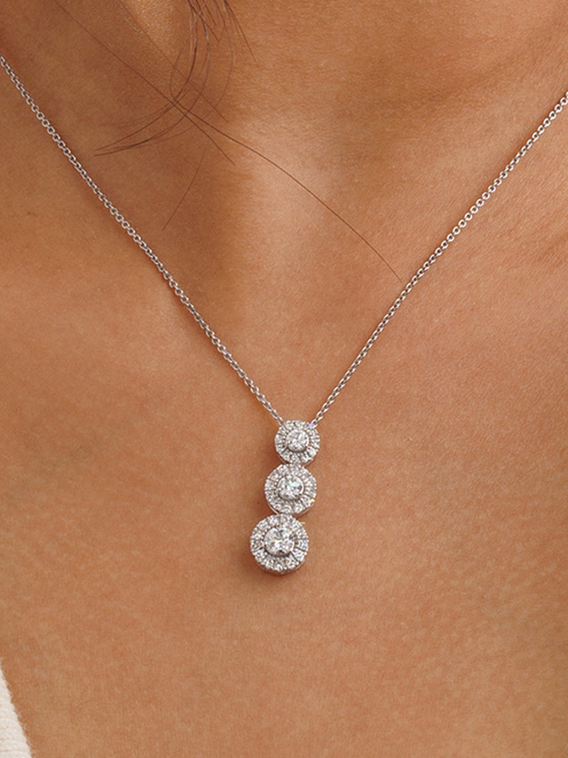 Three halo necklet worn at the collarbone on a fine silver chain.