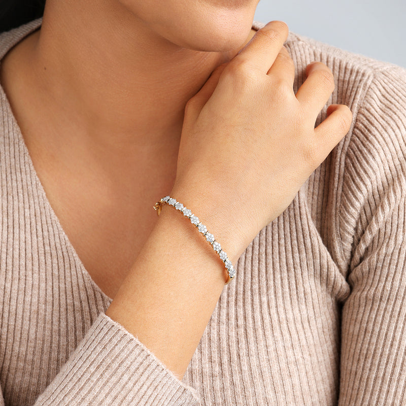 A woman radiates elegance in Keemti Jewels' Blossom Spark Diamond Bracelet over a beige ribbed top.