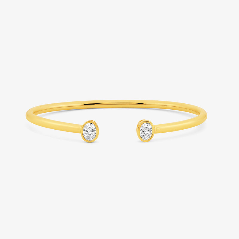 Keemti Jewels Oval Luxe Diamond Bracelet features a thin gold band with round diamonds at each open end.