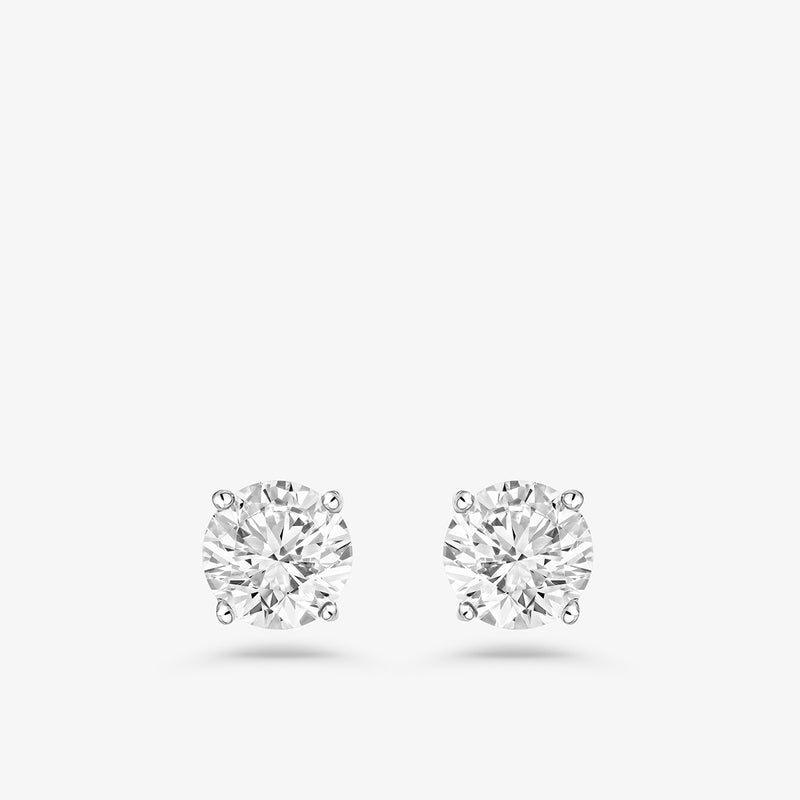 Keemti Jewels Infinity Solitaire Stud Earrings—timeless, modern round diamond studs with classic four-prong settings.