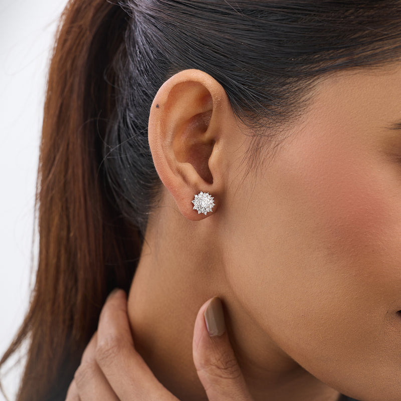 Close-up of a woman wearing Keemti Jewels' Blossom Aura Diamond Stud Earrings, hand touching her neck.