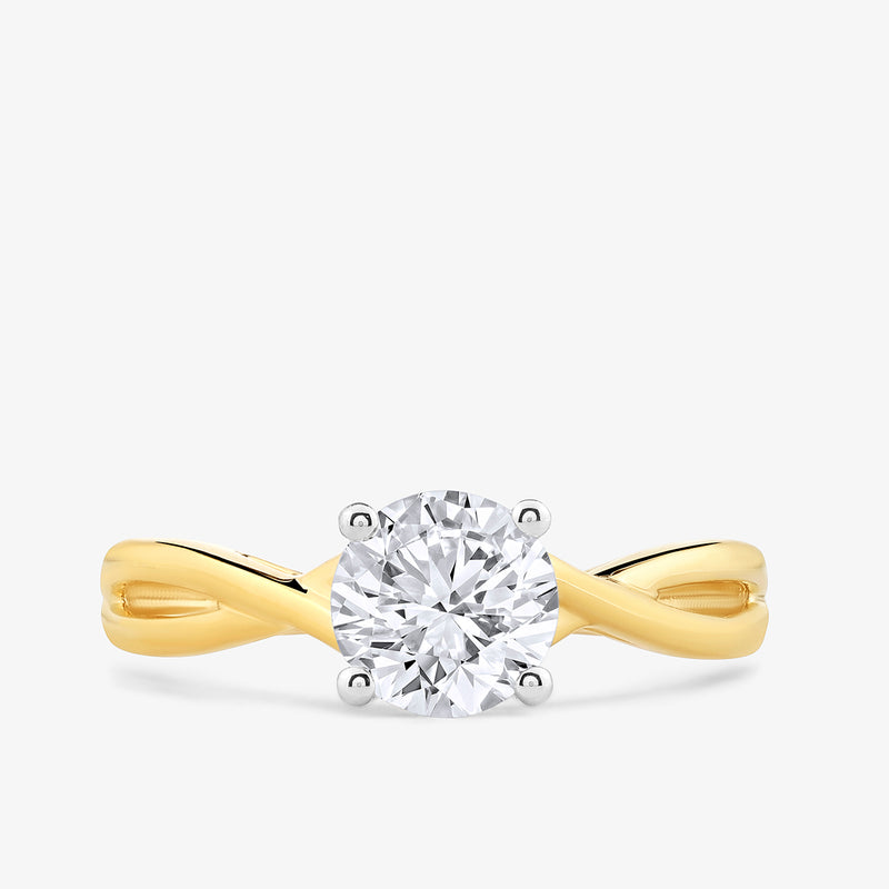 Keemti Jewels' Serene Swirl Solitaire Ring: a twisted band gold ring with a center diamond in four prongs.