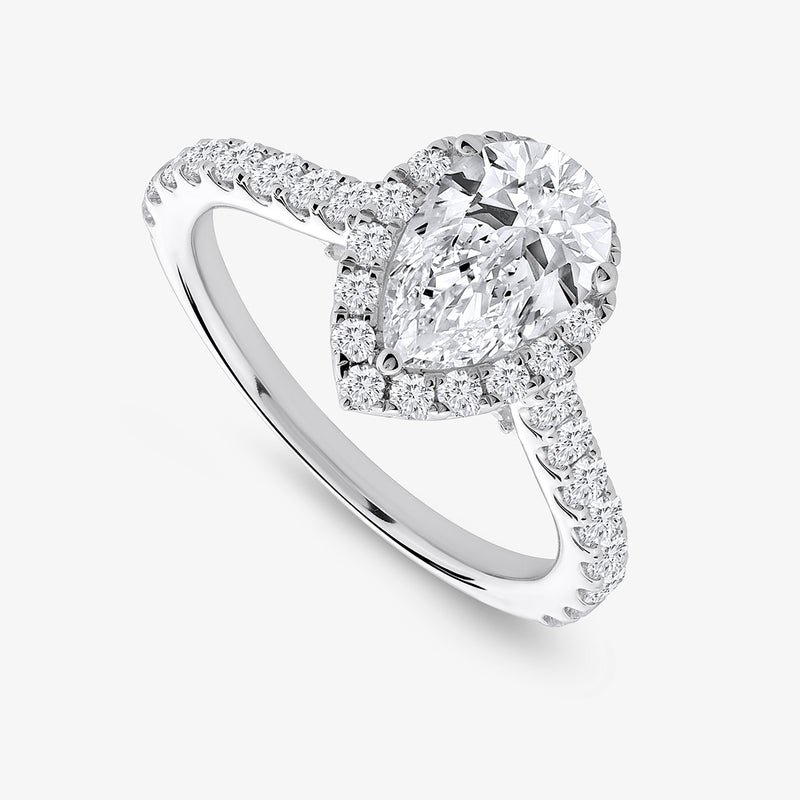 Keemti Jewels' Pear Tiered Halo Diamond Ring features a pear diamond and a pavé band with sparkling accents.