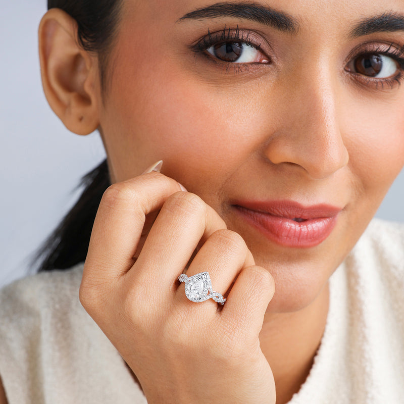 A woman smiles softly, displaying the Keemti Jewels Rose Dewdrop Diamond Bridal Ring on her finger.