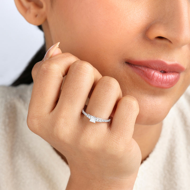 A woman with soft makeup smiles gently, showcasing the Keemti Jewels Timeless Princess Glow Diamond Ring.