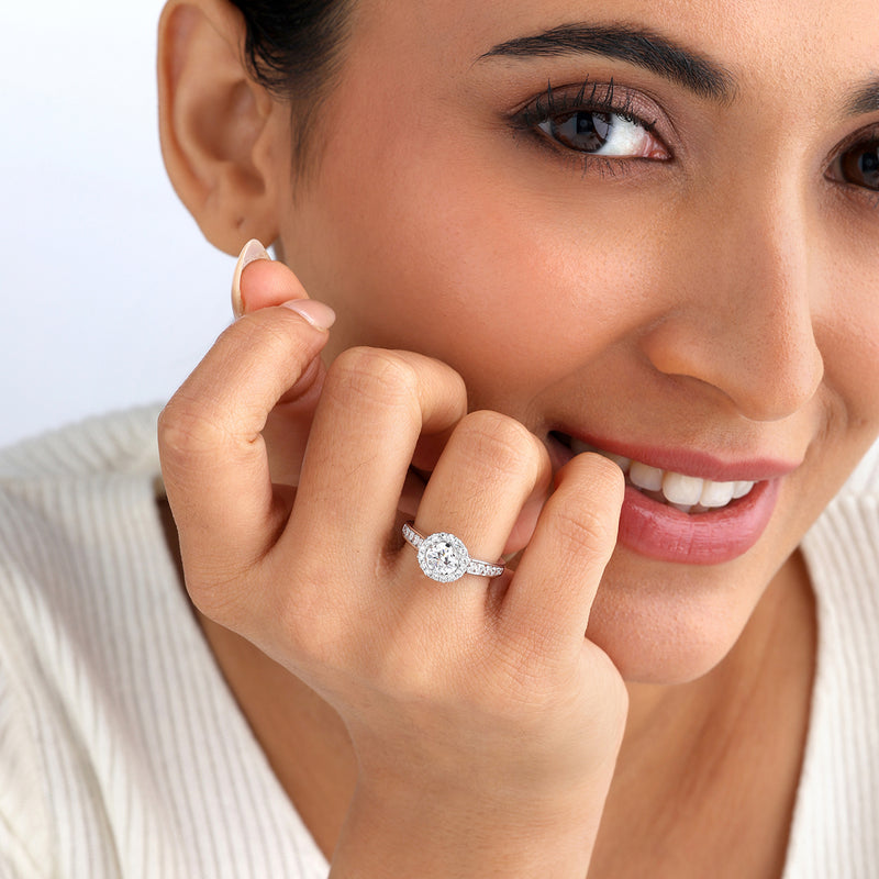A woman smiles, touching her face while wearing the Keemti Jewels Eternal Circle Of Love Diamond Ring.