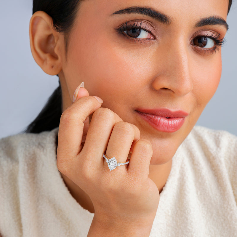 A woman with dark hair smiles, displaying the Keemti Jewels Eternal Halo Marquise Solitaire Ring on her left hand.