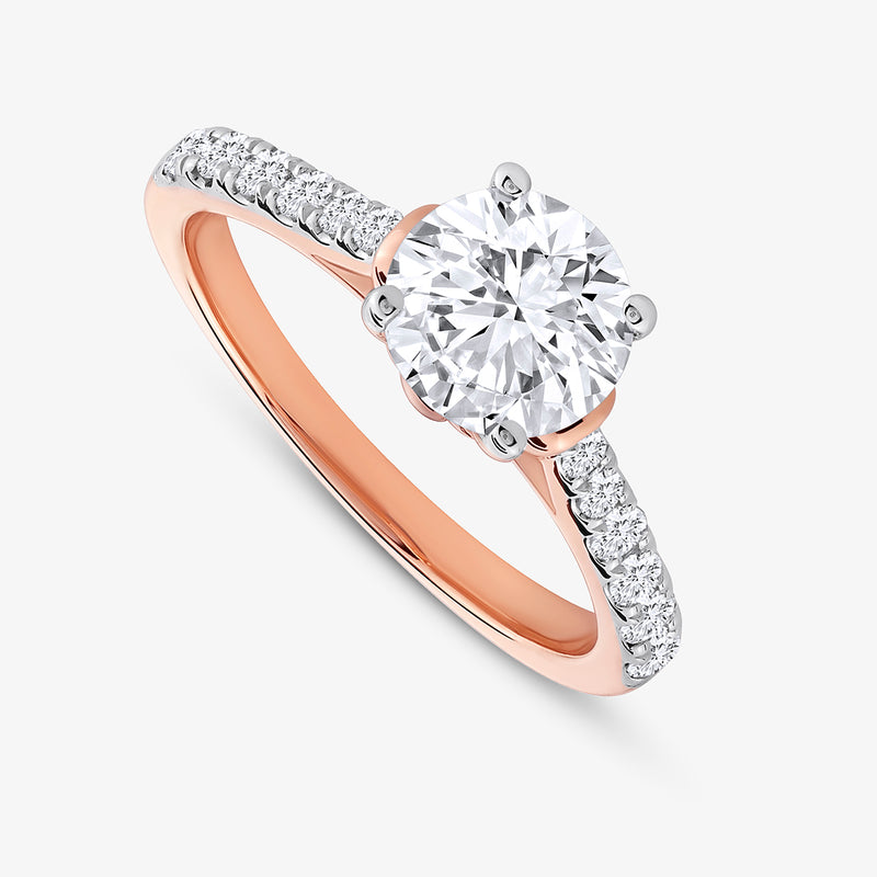 Keemti Jewels Timeless Cathedral Solitaire Ring features a round diamond center and side stones on a white background.