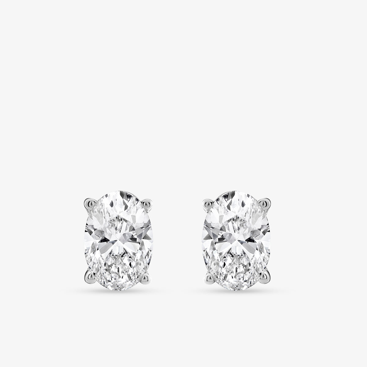 Keemti Jewels TIMELESS Oval Solitaire Stud Earrings in white metal, classic design on a plain white background.