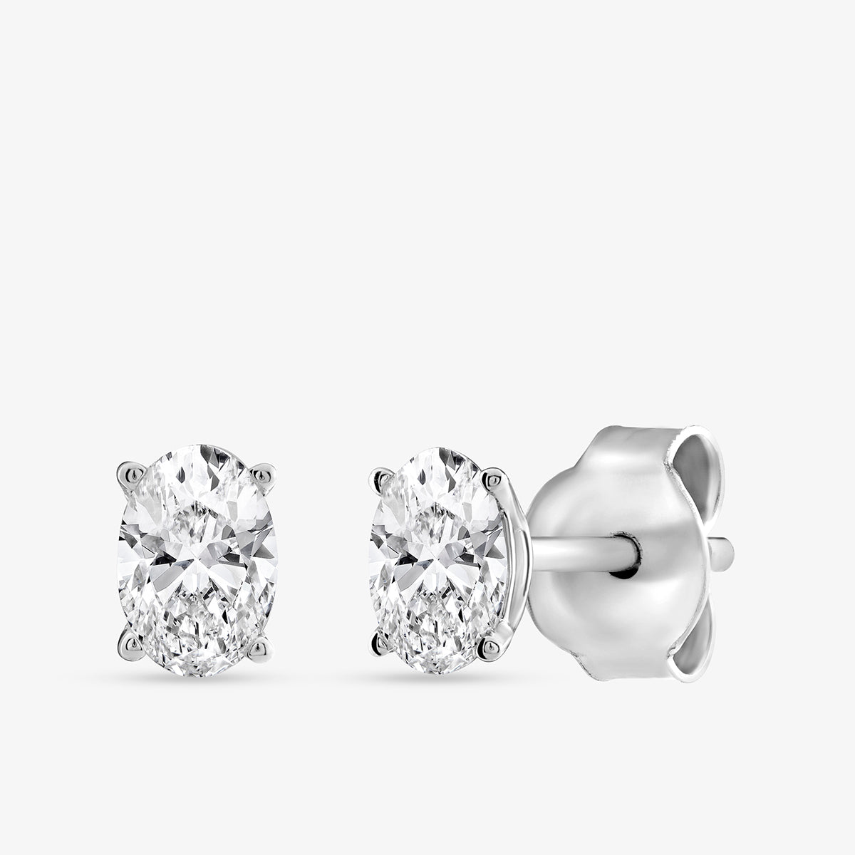 Keemti Jewels TIMELESS Oval Solitaire Stud Earrings with silver prongs and butterfly backs—an elegant accessory.