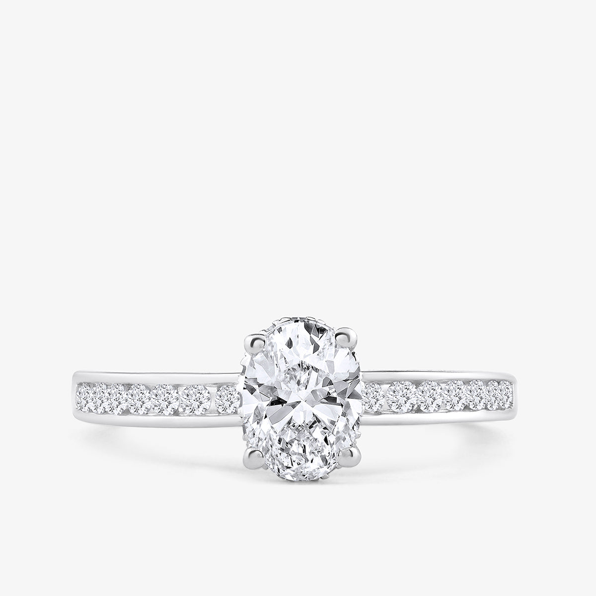 The Oval Grace Solitaire Ring by Keemti Jewels features an oval diamond center and accents in white gold, shown on white.